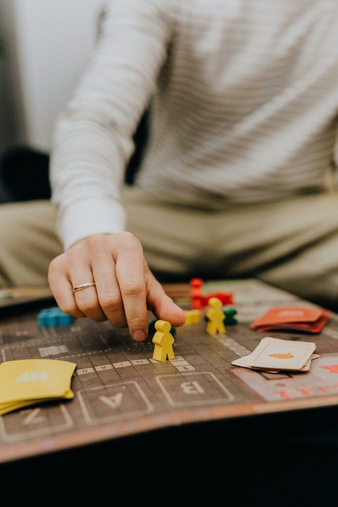Close-up of a hand placing a game piece on a board, adding strategy to the session.