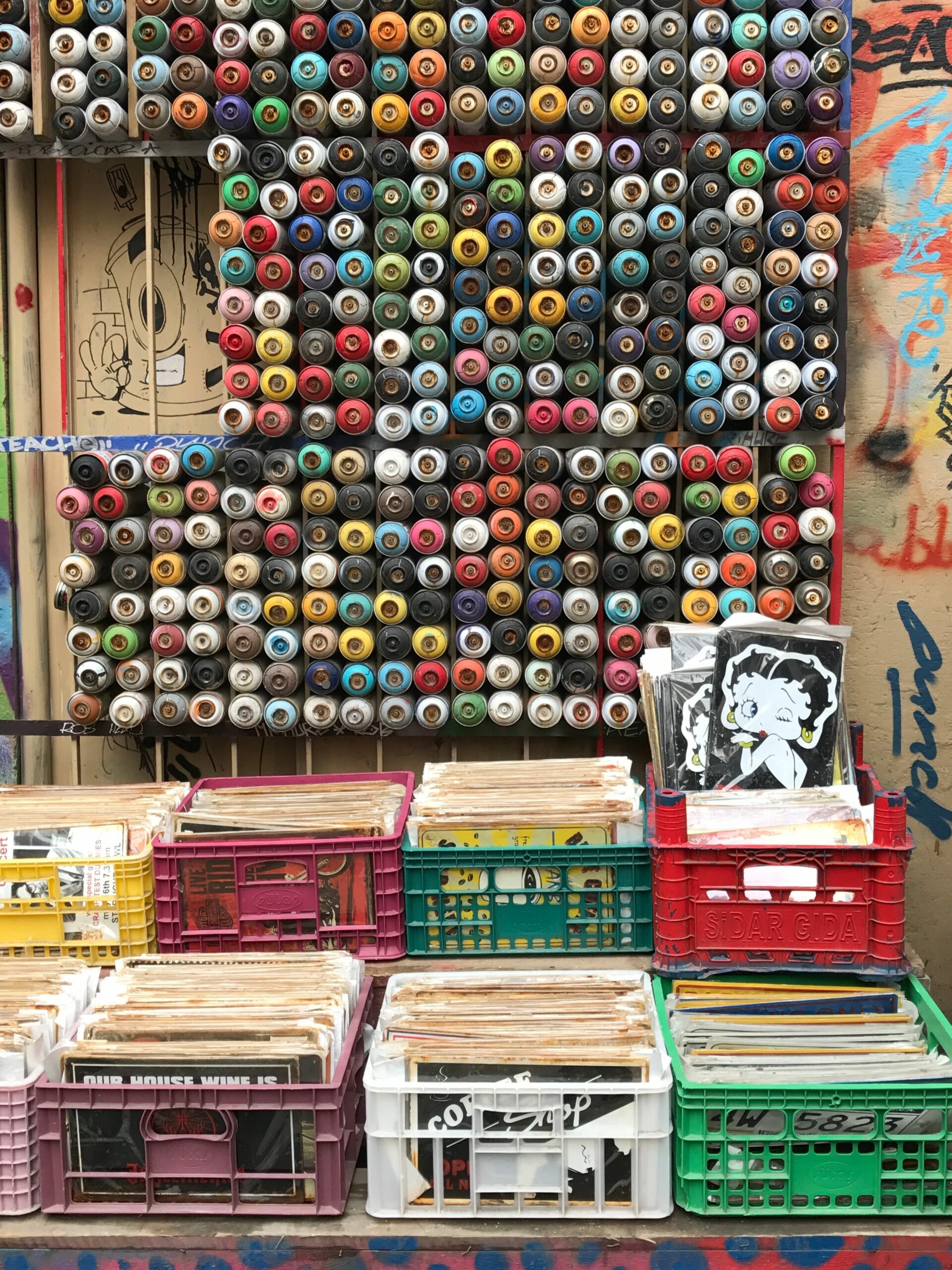 Vibrant collection of spray paint cans at a colorful market in Beyoğlu, Istanbul.